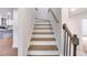 Bright staircase featuring wood railing and hardwood flooring at 597 Woodcrest Manor Dr, Stone Mountain, GA 30083