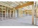 The unfinished basement includes bare studs, concrete floors, exposed beams, and the framing for a staircase at 932 Melville Dr, Stockbridge, GA 30281