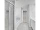 Bathroom featuring a glass shower, soaking tub and large tile flooring at 932 Melville Dr, Stockbridge, GA 30281