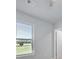 Well-lit bedroom featuring a window with blinds, ceiling fan, and closet at 932 Melville Dr, Stockbridge, GA 30281