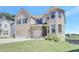 Charming two-story brick home with a well-kept lawn, showcasing its classic design at 932 Melville Dr, Stockbridge, GA 30281