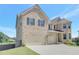 Brick home featuring a three-car garage and a neatly landscaped lawn, perfect for families at 932 Melville Dr, Stockbridge, GA 30281