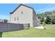 Backyard view of two-story house, featuring lush green grass and a fenced perimeter at 932 Melville Dr, Stockbridge, GA 30281