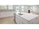Kitchen island featuring a stainless steel sink and dishwasher with open-concept to living area at 932 Melville Dr, Stockbridge, GA 30281