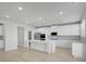 Modern open kitchen with white cabinets, stainless steel appliances, and spacious center island at 932 Melville Dr, Stockbridge, GA 30281