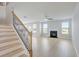 Open-concept living area featuring a cozy fireplace and staircase with modern metal spindles at 932 Melville Dr, Stockbridge, GA 30281