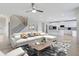 Staged living room featuring modern furniture, open to the kitchen with a spacious island at 932 Melville Dr, Stockbridge, GA 30281