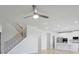 Bright and airy living area with staircase and open floor plan connecting to the kitchen at 932 Melville Dr, Stockbridge, GA 30281