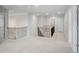 Bright, carpeted open loft space with wood and metal railing and access to multiple bedrooms at 932 Melville Dr, Stockbridge, GA 30281