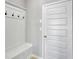 The mudroom features a bench, coat hooks, and access to the garage via a paneled door at 932 Melville Dr, Stockbridge, GA 30281