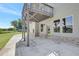 A concrete patio beneath the house has supporting posts and leads to a door that leads inside the home at 932 Melville Dr, Stockbridge, GA 30281