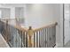 View of the home's staircase with wood banisters and black iron spindles at 932 Melville Dr, Stockbridge, GA 30281