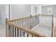 View of the home's staircase with wood banisters and black iron spindles at 932 Melville Dr, Stockbridge, GA 30281