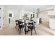 Bright dining area with modern table set, hardwood floors and view of living room and kitchen at 1980 Oakdale Se Ct, Smyrna, GA 30082