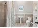 Bathroom featuring a glass block shower, skylight, and a pedestal sink at 4472 Cavallon Nw Way, Acworth, GA 30101
