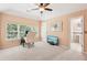 Bedroom with neutral walls, carpet and natural light; features a desk, television and ensuite bathroom at 4472 Cavallon Nw Way, Acworth, GA 30101