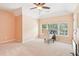 Bedroom with neutral walls, carpet and natural light; features a desk and a television at 4472 Cavallon Nw Way, Acworth, GA 30101