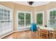 Sun-drenched breakfast nook with a view of the backyard, wood floors, and modern lighting at 4472 Cavallon Nw Way, Acworth, GA 30101
