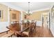 Sophisticated dining room with wainscoting, wood floors, and a traditional chandelier at 4472 Cavallon Nw Way, Acworth, GA 30101
