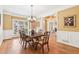 Elegant dining room with hardwood floors, chandelier, large window, and view into the living room at 4472 Cavallon Nw Way, Acworth, GA 30101
