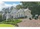 Well-maintained home with mature trees, featuring a basketball hoop and neatly trimmed greenery at 4472 Cavallon Nw Way, Acworth, GA 30101
