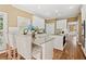 Bright kitchen with white cabinetry, granite countertops, stainless steel appliances, and eat-in island at 4472 Cavallon Nw Way, Acworth, GA 30101
