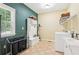 Well-organized laundry room featuring a built-in storage bench and modern washer and dryer at 4472 Cavallon Nw Way, Acworth, GA 30101