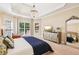 Bright primary bedroom featuring a tray ceiling, large windows, and mirrored dresser at 4472 Cavallon Nw Way, Acworth, GA 30101