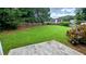 The backyard features a large green lawn surrounded by a wood fence and mature trees at 4707 Golod Way, Lithonia, GA 30038