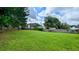 Large, grassy backyard is enclosed by a wooden fence and features mature shade trees at 4707 Golod Way, Lithonia, GA 30038