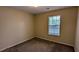 This bedroom features neutral walls, carpeted flooring, and a window for natural light at 4707 Golod Way, Lithonia, GA 30038