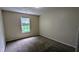 Bedroom featuring neutral walls, carpeted flooring, and a window with natural light at 4707 Golod Way, Lithonia, GA 30038