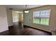 Well-lit dining area with dark hardwood floors and views into the living spaces at 4707 Golod Way, Lithonia, GA 30038