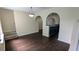 Open dining area with dark hardwood floors and arched openings to the kitchen at 4707 Golod Way, Lithonia, GA 30038