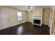 Inviting living room featuring a fireplace, ceiling fan, and hardwood floors at 4707 Golod Way, Lithonia, GA 30038