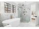 Luxury bathroom featuring marble tile, soaking tub, and a glass-enclosed shower at 125 Maison Court, Roswell, GA 30076