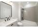 Elegant bathroom featuring gray tiled walls, a bathtub, and a vanity with a black framed mirror at 125 Maison Court, Roswell, GA 30076