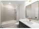 Clean bathroom features a tub and shower combination with decorative tile and a large mirror at 125 Maison Court, Roswell, GA 30076