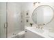 Elegant bathroom features a walk-in shower with glass door, a round mirror and vanity at 125 Maison Court, Roswell, GA 30076