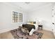 Bright bedroom features hardwood floors, large window and a beautifully decorated queen size bed at 125 Maison Court, Roswell, GA 30076