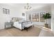 Serene bedroom with natural light, a decorative rug, and views of the surrounding trees at 125 Maison Court, Roswell, GA 30076