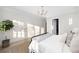 Bright bedroom with a cozy rug, bed, and a lush green plant at 125 Maison Court, Roswell, GA 30076