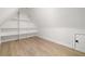 Finished bonus room featuring hardwood floors, white walls, and built in shelving space at 125 Maison Court, Roswell, GA 30076