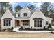 Charming two-story home with a brick facade, dark window trim, and a well-manicured front lawn at 125 Maison Court, Roswell, GA 30076