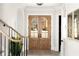 Inviting foyer with elegant double doors, a staircase, and hardwood floors throughout at 125 Maison Court, Roswell, GA 30076