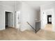 Upstairs hallway with hardwood floors and staircase with railing, offers multiple entryways at 125 Maison Court, Roswell, GA 30076