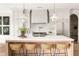 Bright kitchen featuring a large island with seating, modern appliances, and designer pendant lighting at 125 Maison Court, Roswell, GA 30076