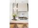 Elegant kitchen showcasing a white island with bar stools, pendant lighting, and modern appliances at 125 Maison Court, Roswell, GA 30076
