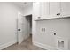 Bright laundry room features white cabinetry, tile flooring and convenient washer and dryer hookups at 125 Maison Court, Roswell, GA 30076
