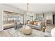 Open-concept living room with a sliding glass door to the porch, grey couch, and white accents at 125 Maison Court, Roswell, GA 30076